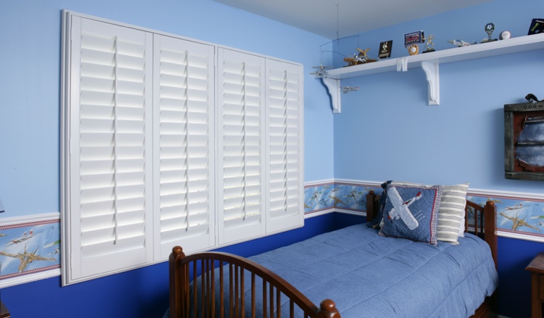 Blue kids bedroom with white plantation shutters in Washington DC 